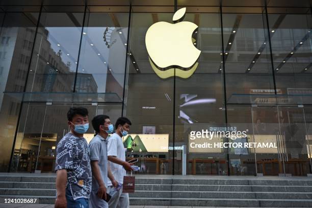 Pedestrians walk past an Apple Store in the Huangpu district of Shanghai on June 1 following the easing of Covid-19 restrictions in the city after a...