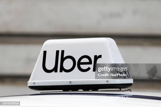 Uber taxi sign is seen on a car in Krakow, Poland, on May 30, 2022.