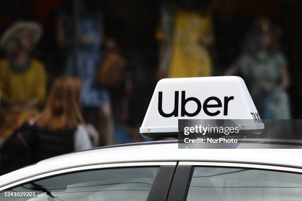 Uber taxi sign is seen on a car in Krakow, Poland, on May 30, 2022.