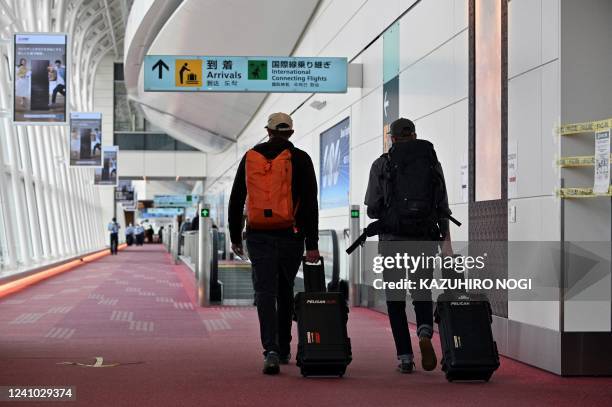 Passengers head to a Covid-19 quarantine station for clearance following their arrival at Tokyo's Haneda Airport on June 1, 2022.