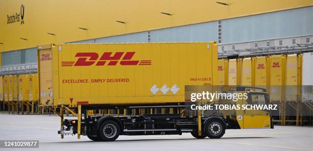 Truck with a containers bearing the logo of German logistics giant DHL is pictured at the loading zone of the new parcel distribution centre operated...