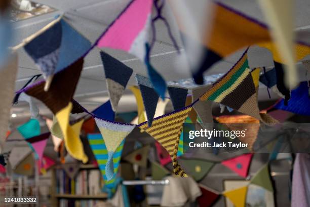 Knitted bunting hangs at the Beccles Community Hub ahead of the Platinum Jubilee of Queen Elizabeth II on June 1, 2022 in Beccles, England. The...