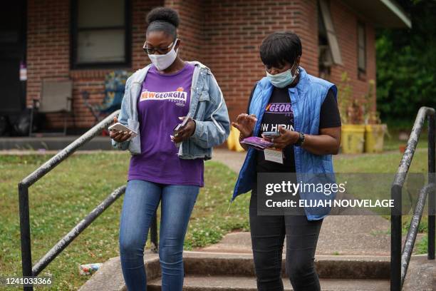 New Georgia Project canvassers Kayla McCall and Mardie Hill go door-to-door to inform residents about the upcoming primary election on May 23 in East...