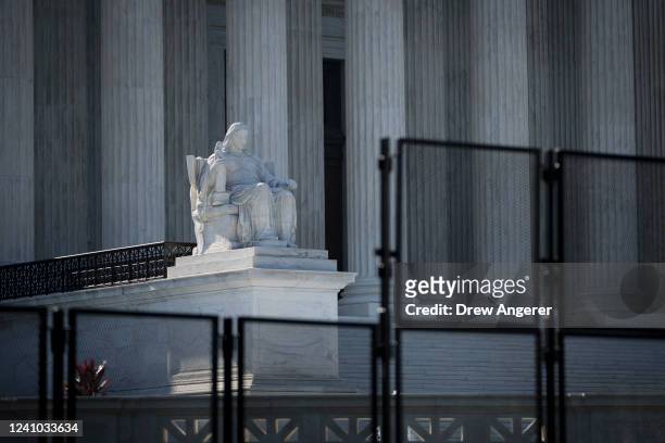 View of the U.S. Supreme Court through security fencing on June 1, 2022 in Washington, DC. The country continues to wait for an official decision in...