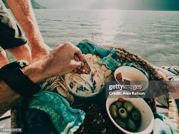 pov of being served a charcuterie appetizer plater on the sea shore - fat guy on beach bildbanksfoton och bilder