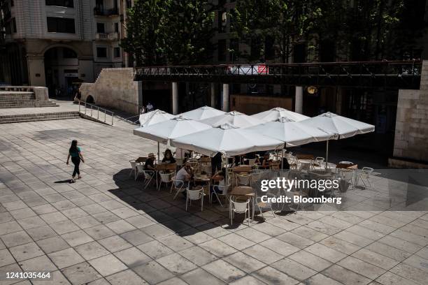 Customers shelter from the sun under parasols at a cafe terrace area in Lleida, Spain, on Wednesday, June 1, 2022. Temperatures in Spain will...
