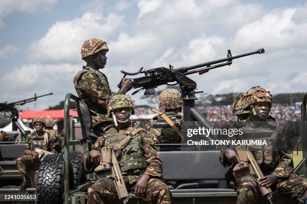 Soldiers from the Kenya Defence Forces march past the presidential dias in their vehicles during commemorations of Kenya's Madaraka Day, that is...