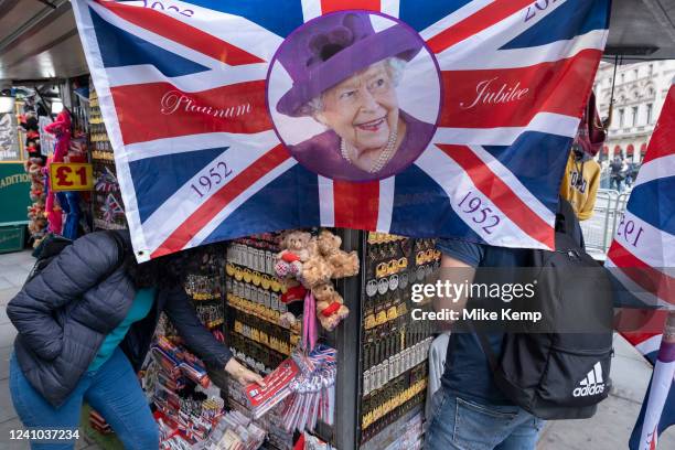 Union Flags with the Queen's face for sale at a souvenir seller stall in celebration of Queen Elizabeth II's upcoming Platinum Jubilee on 1st June...