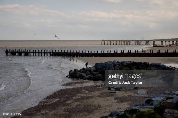 Boy runs along the beach as a seagull takes flight on June 1, 2022 in Lowestoft, England.