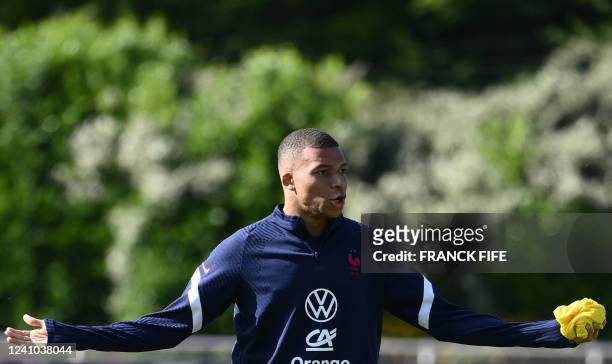 France's forward Kylian Mbappe gestures during a training session in Clairefontaine-en-Yvelines on June1, 2022 as part of the team's preparation for...