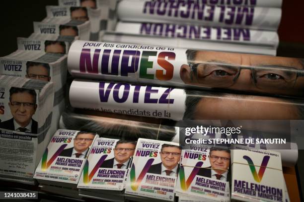 Campaign leaflets and posters are pictured during a political meeting of French left-wing electoral coalition Nupes at the Olympe-de-Gouge venue in...
