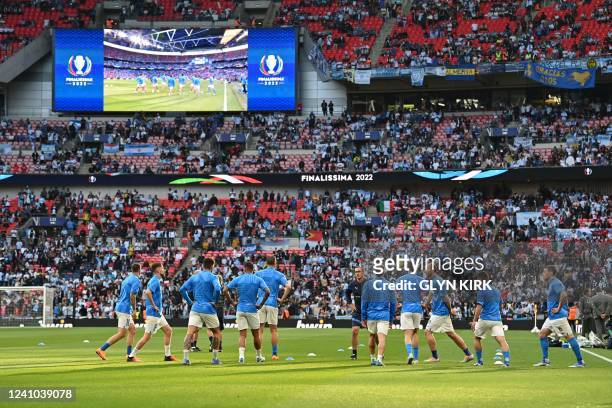 Italy's players warm up ahead of the 'Finalissima' International friendly football match between Italy and Argentina at Wembley Stadium in London on...