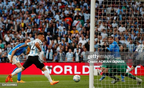 Argentina's striker Lautaro Martinez shoots to score the opening goal of the 'Finalissima' International friendly football match between Italy and...