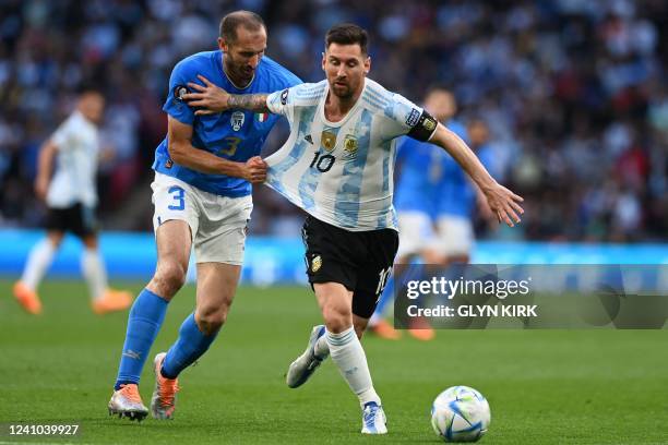 Italy's defender Giorgio Chiellini holds onto Argentina's striker Lionel Messi during the 'Finalissima' International friendly football match between...