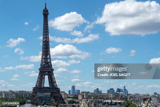 This picture taken on June 1, 2022 shows the Eiffel Tower with La Defense business district in the background in Paris.