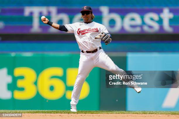 Jose Ramirez of the Cleveland Guardians makes a throw to first base on a single by Andrew Benintendi of the Kansas City Royals during the third...