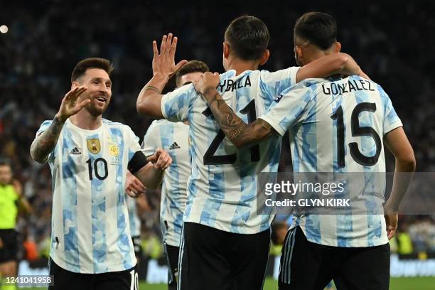 Argentina's striker Paulo Dybala celebrates with teammates after scoring their third goal during the 'Finalissima' International friendly football...