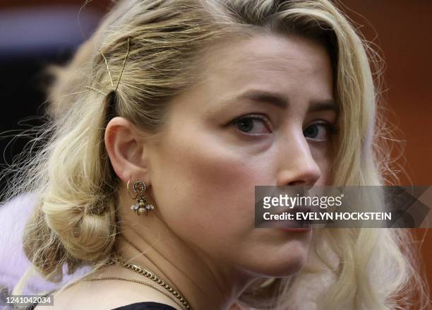 Actor Amber Heard waits before the jury said that they believe she defamed ex-husband Johnny Depp while announcing split verdicts in favor of both...