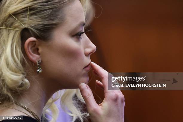 Actor Amber Heard waits before the jury said that they believe she defamed ex-husband Johnny Depp while announcing split verdicts in favor of both...