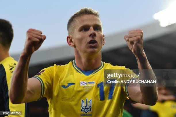 Ukraine's midfielder Oleksandr Zinchenko applauds the fans following the FIFA World Cup 2022 play-off semi-final qualifier football match between...