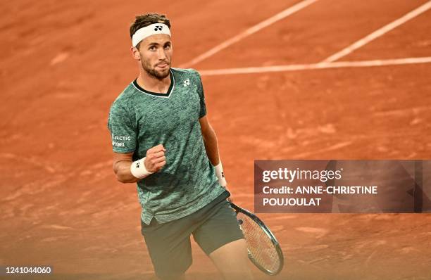 Norway's Casper Ruud reacts after a point against Denmark's Holger Rune during their men's quarter-final singles match on day eleven of the...