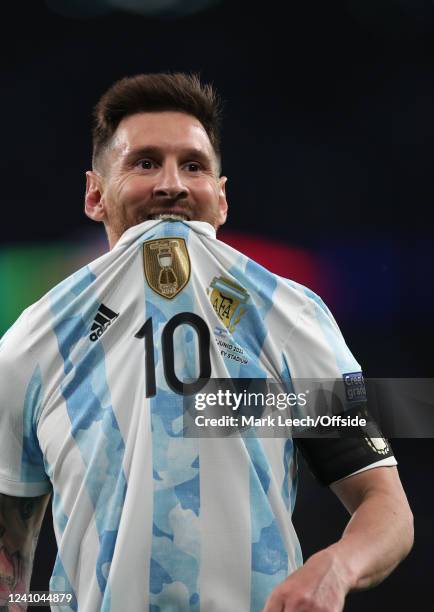 Lionel Messi of Argentina reacts by biting his jersey during the Finalissima match, Italy v Argentina at Wembley Stadium on June 1, 2022 in London,...