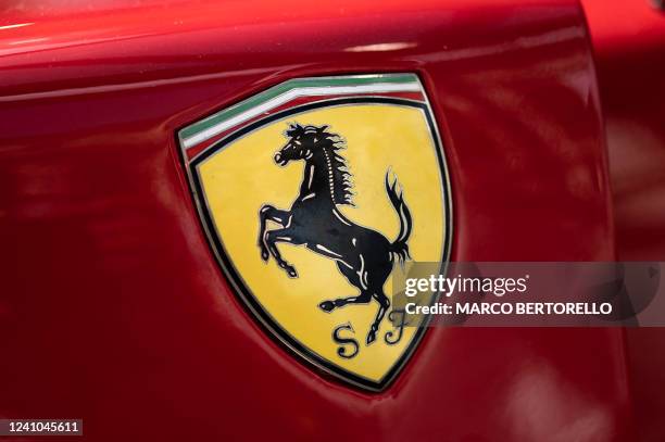 The logo of Italian manufacturer of luxury sports cars Ferrari is pictured on a car in Modena, Northern Italy, during the Motor Valley Fest, the fair...