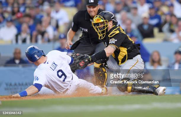 Catcher Tyler Heineman of the Pittsburgh Pirates tags out Gavin Lux of the Los Angeles Dodgers trying to score on a fly out by Trea Turner for the...