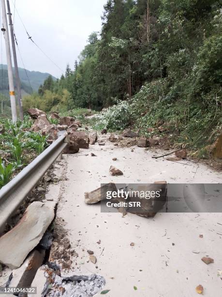 Rocks block a road after a 6.1-magnitude earthquake which killed four people and injured 14 others in Yaan, in China's southwestern Sichuan province...
