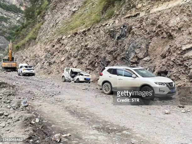 Damaged cars are seen after a 6.1-magnitude earthquake which killed four people and injured 14 others in Yaan, in China's southwestern Sichuan...