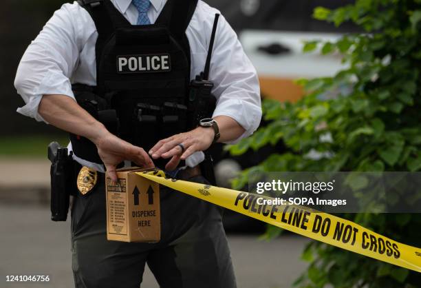 Police officer pulls police tape after a shooting in a nail salon in Pittston. Reports of an active shooter in a Walmart turned into a shooting in an...