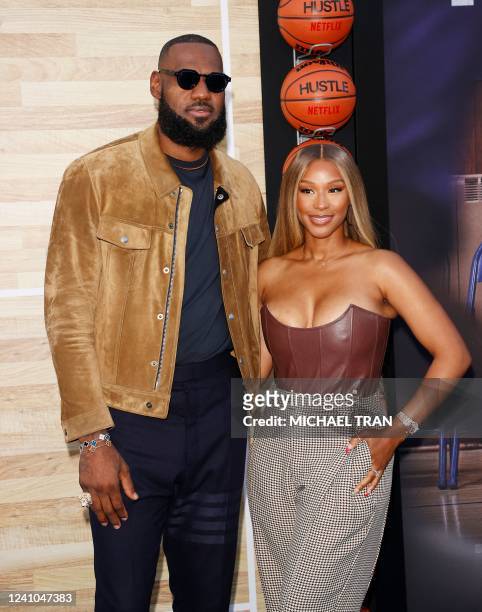 Basketball player LeBron James and his wife Savannah Brinson James arrive for Netflix's Los Angeles premiere of "Hustle" held at the Westwood Regency...