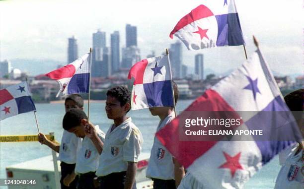 Panamanian children hold national flags 01 October during a ceremony in Panama City in which the US military turned the 207-acre military base of...