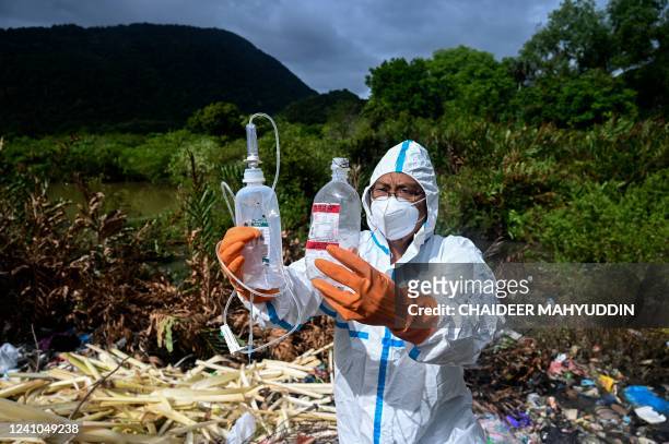 Volunteer checks plastic waste while conducting research on the amount of micro-plastics contained in the water at a beach in Pekan Bada, Indonesia's...