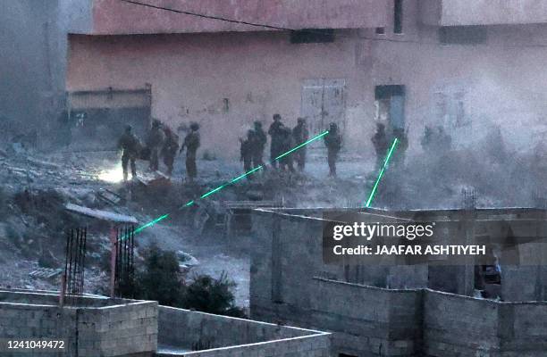 Israeli troops use laser beams near the family house of Diaa Hamarsha , a Palestinian who in March killed five people in a gun attack in the Orthodox...