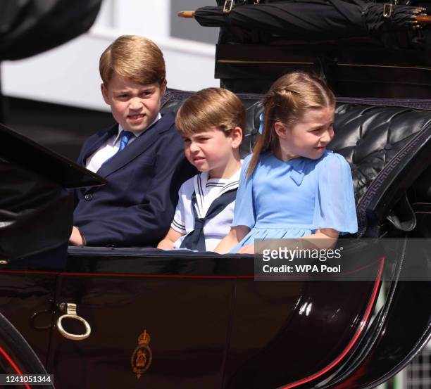 Prince George of Cambridge, Prince Louis of Cambridge and Princess Charlotte of Cambridge travel in a horse-drawn carriage during Trooping The Colour...