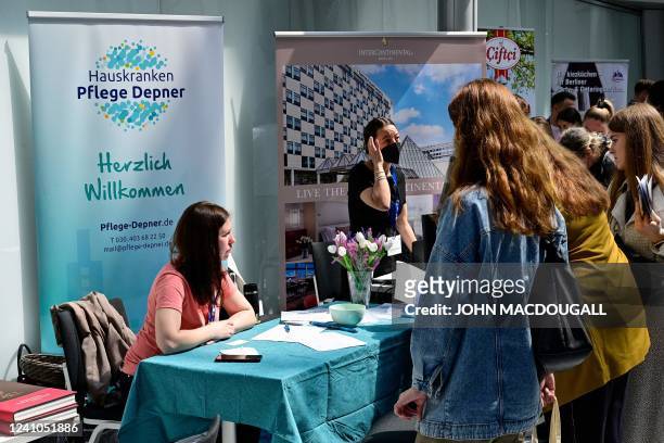 Refugees from Ukraine line up for information at a booth at a job fair for Ukrainians organised by the Chamber of Industry and Commerce in Berlin on...