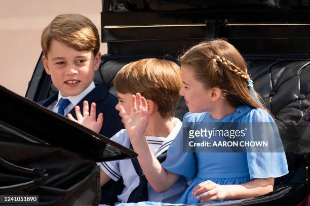 Britain's Prince George of Cambridge , Britain's Prince Louis of Cambridge and Britain's Princess Charlotte of Cambridge travel in a horse-drawn...