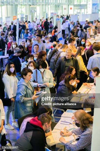 Participants in a job fair for Ukrainian refugees organized by the Berlin Chamber of Industry and Commerce and the Employment Agency crowd...