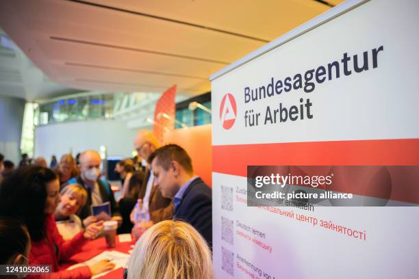 People stand at a job fair for Ukrainian refugees organized by the Berlin Chamber of Industry and Commerce and the Federal Employment Agency. More...