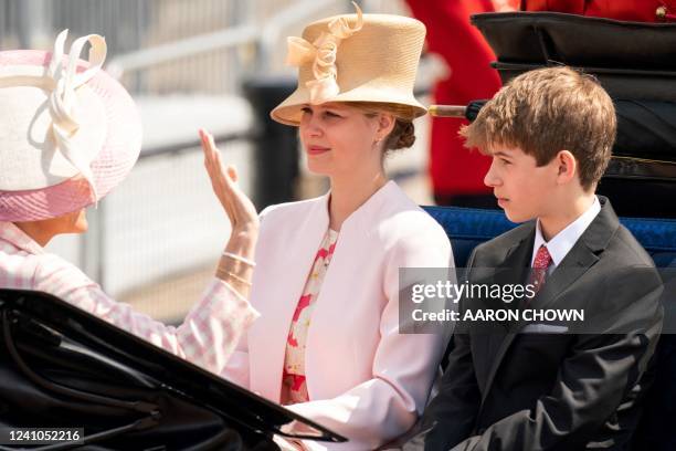 Britain's Sophie, Countess of Wessex , Britain's Lady Louise Windsor and James, Viscount Severn travel in a horse-drawn carriage during the Queen's...