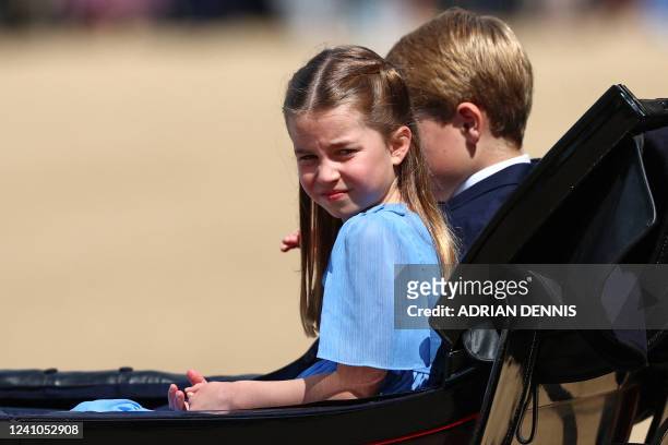 Britain's Princess Charlotte of Cambridge and Britain's Prince George of Cambridge travel in a horse-drawn carriage during the Queen's Birthday...