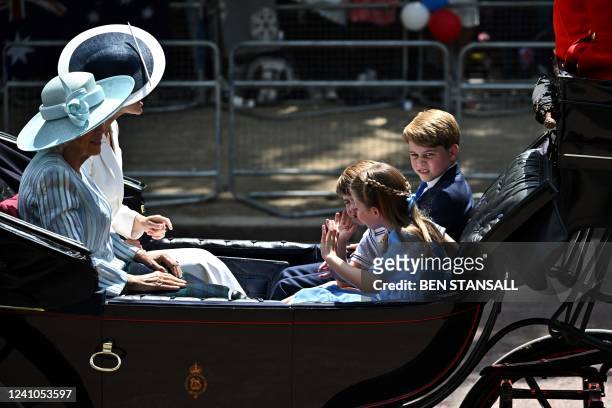 Britain's Prince George of Cambridge, Britain's Prince Louis of Cambridge and Britain's Princess Charlotte of Cambridge travel in a horse-drawn...