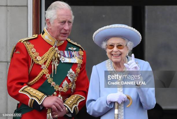 Britain's Queen Elizabeth II stands with Britain's Prince Charles, Prince of Wales to watch a special flypast from Buckingham Palace balcony...