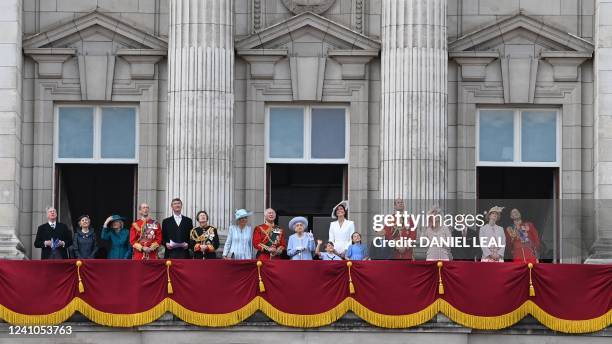 Britain's Queen Elizabeth II stands with members of the Royal family to watch a special flypast from Buckingham Palace balcony following the Queen's...