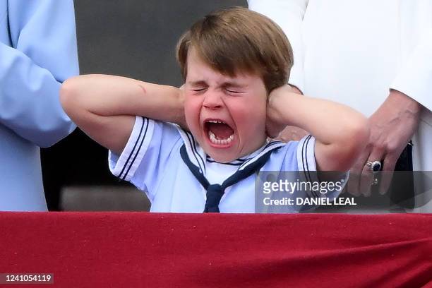 Britain's Prince Louis of Cambridge reacts as he watches a special flypast from Buckingham Palace balcony following the Queen's Birthday Parade, the...
