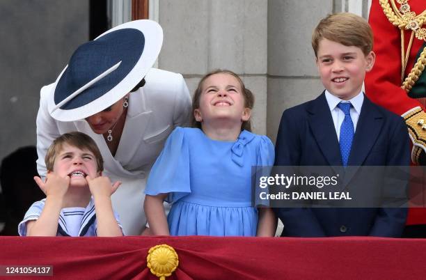 Britain's Catherine, Duchess of Cambridge, talks to Britain's Prince Louis of Cambridge , as they stand with Britain's Princess Charlotte of...