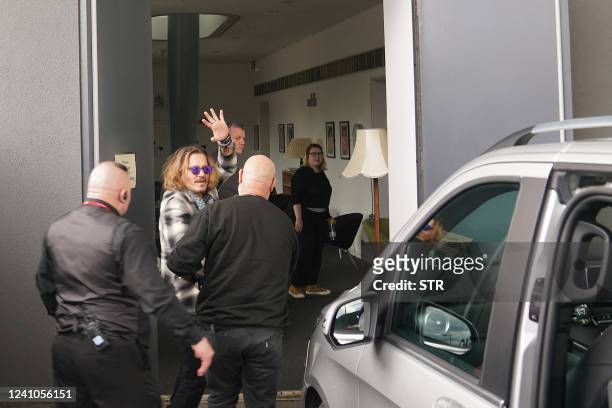 Actor Johnny Depp waves upon arrival at the Sage Gateshead venue, in Newcastle-upon-Tyne, north east England, on June 2, 2022 to appear on stage with...