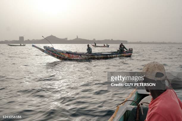 Teams of fisherman manuever amongst each other before setting anchor and dropping fishing lines to catch larger schools of fish, most often mackerel,...