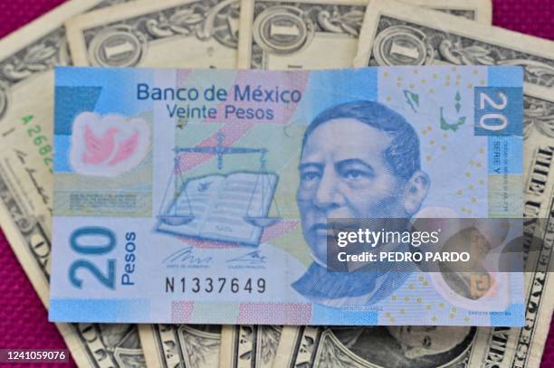 Image of a 20 Mexican Peso bill which is equivalent to one US dollar in Mexico City, on June 2, 2022. - A stable political outlook in the face of...